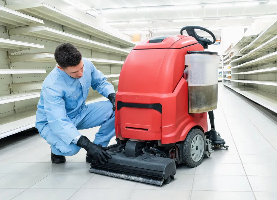 Operator checking squeegee and recovery after a retail floor trial
